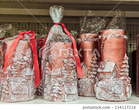 Close-up of pink Christmas candles featuring intricate cut-out patterns and festive decorations. The decorative candles add a cozy and elegant holiday touch, suitable for seasonal displays, Christmas Close-up of pink Christmas candles featuring intricate cut-out patterns and festive decorations. The decorative candles add a cozy and elegant holiday touch, suitable for seasonal displays, Christmas 134117218