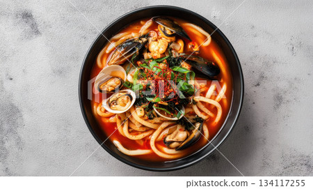 Spicy Korean udon soup with seafood, mussels and clams, gourmet noodle bowl 134117255
