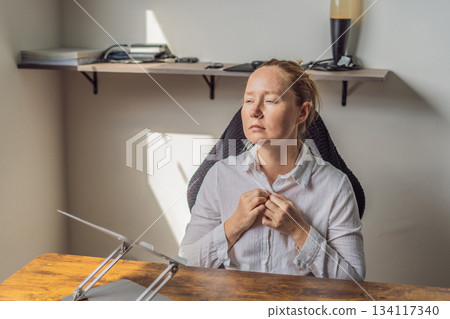 Woman working in her home office, focused on her laptop and daily tasks, creating a calm and productive workspace. Remote work, professional lifestyle and modern productivity concept representing 134117340