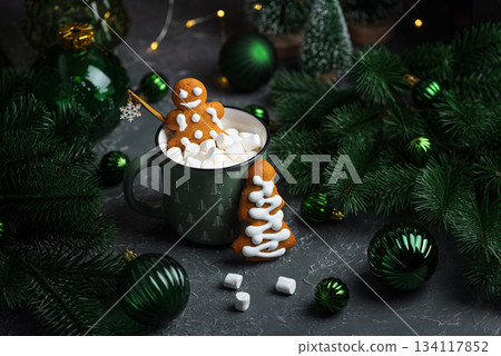 Gingerbread Cookie Man into Christmas Mug with Marshmallows and Festive Decor 134117852
