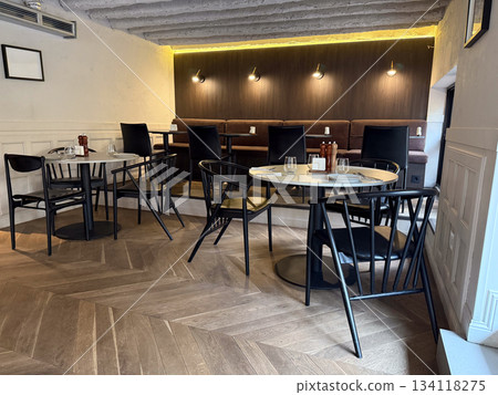 Modern cafe interior at lunchtime. Quiet seating, restaurant ambiance, urban lifestyle and social meeting place atmosphere Modern cafe interior at lunchtime. Quiet seating, restaurant ambiance, urban lifestyle and social meeting place atmosphere 134118275