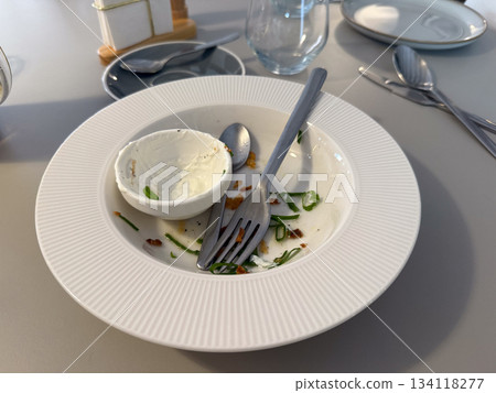 Finished plate after meal in cafe, dirty plate. Dining moment, completion, habit, casual experience and everyday food ritual 134118277