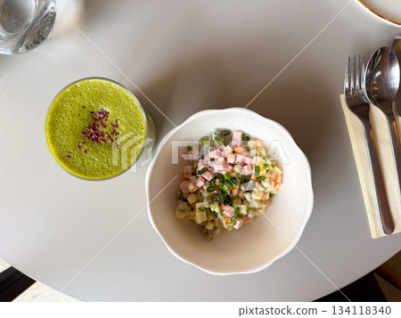 Matcha latte and Olivier salad top view. Friendly lunch setup, cozy atmosphere and slow mindful eating 134118340