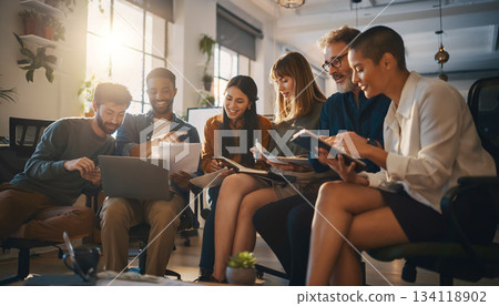 Group of friends sharing ideas while working together in a bright indoor space during the afternoon Group of friends sharing ideas while working together in a bright indoor space during the afternoon 134118902