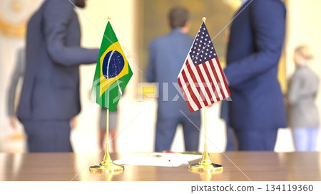 Brazil and United States economic meeting with table flags, 3D rendering Brazil and United States economic meeting with table flags, 3D rendering 134119360