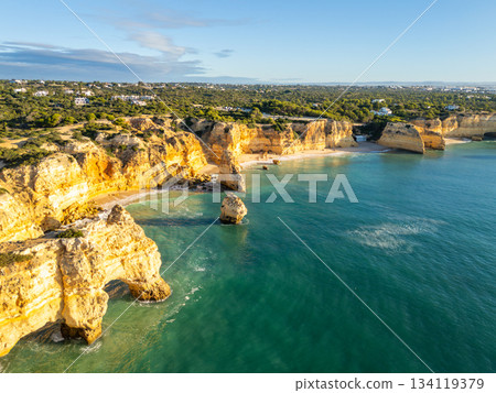 Marinha Beach, Cliffs and Atlantic Ocean on Sunny Morning. Aerial View. Portugal Marinha Beach, Cliffs and Atlantic Ocean on Sunny Morning. Aerial View. Portugal 134119379