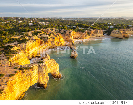 Marinha Beach, Cliffs and Atlantic Ocean on Sunny Morning. Aerial View. Portugal Marinha Beach, Cliffs and Atlantic Ocean on Sunny Morning. Aerial View. Portugal 134119381