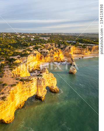 Marinha Beach, Cliffs and Atlantic Ocean on Sunny Morning. Aerial View. Portugal 134119398