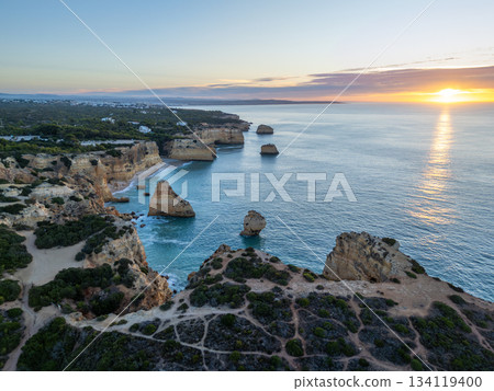 Marinha Beach, Cliffs and Atlantic Ocean at Sunrise. Aerial View. Portugal 134119400