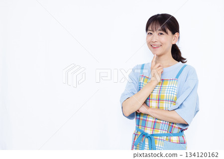 Housewife thinking with a smile 134120162