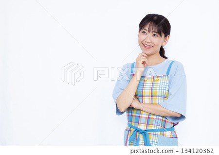 Housewife thinking with a smile Housewife thinking with a smile 134120362