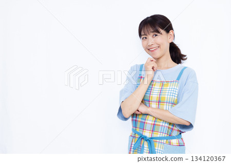 Housewife thinking with a smile 134120367