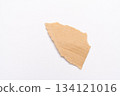 Torn pieces of kraft paper photographed against a white background 134121016