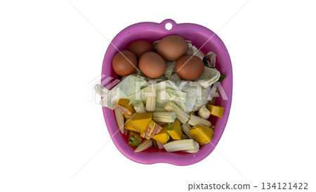 Above of many Ingredients for cooking in the pink pan plastic. Inside with Eggs Cabbage Baby corn and Pumpkin. On isolated white background. Above of many Ingredients for cooking in the pink pan plastic. Inside with Eggs Cabbage Baby corn and Pumpkin. On isolated white background. 134121422