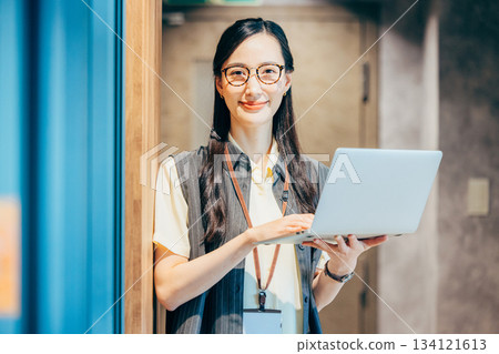 Business woman standing in the office corridor 134121613