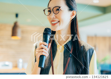 A woman hosting an event in the office A woman hosting an event in the office 134121625
