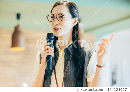 A woman hosting an event in the office A woman hosting an event in the office 134121627