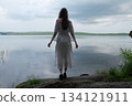 Contemplation by the Lake: Woman in White Off-Shoulder Dress, Back View 134121911