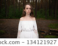Serene Solitude: Woman in White Off-Shoulder Dress amidst Forest Tall Trees 134121927