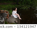 Serene Solitude: Woman in White Dress by Forest Pond 134121947