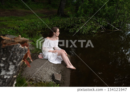 Serene Solitude: Woman in White Dress by Forest Pond Serene Solitude: Woman in White Dress by Forest Pond 134121947