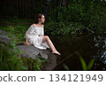 Serene Solitude: Woman in White Dress by Forest Pond 134121949