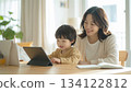 A mother working from home and her child learning online in a bright room. 134122812