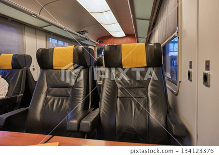 Train trip window view and empty seats Train trip window view and empty seats 134123376