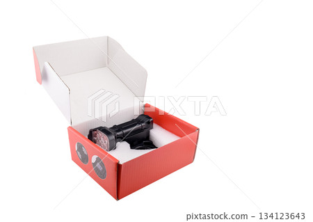 powerful led bicycle headlight in an open cardboard box, studio shot on a white background powerful led bicycle headlight in an open cardboard box, studio shot on a white background 134123643