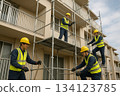 People working at a construction site: Construction workers and scaffolding assembly 0166 134123785