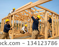 People working at a construction site - Wooden house frame under construction 0167 134123786