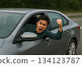 A man in front of a car is depressed. A tense moment in the car. 0168 134123787