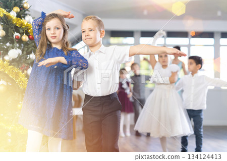 Tween boy and girl performing waltz during Christmas event at school Tween boy and girl performing waltz during Christmas event at school 134124413