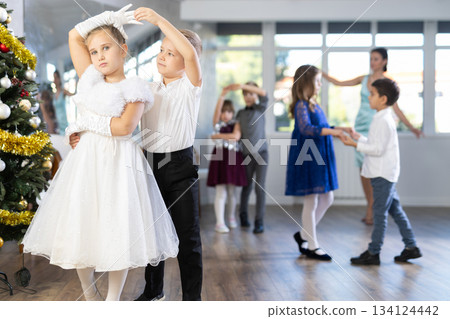Children rehearsing ballroom dance for upcoming Christmas party at school Children rehearsing ballroom dance for upcoming Christmas party at school 134124442