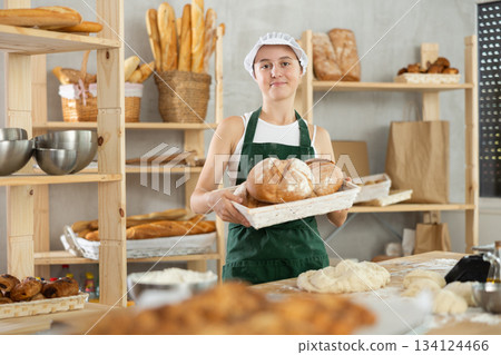 Teen girl holding bread in square wicker basket Teen girl holding bread in square wicker basket 134124466