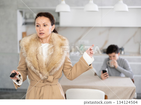 Mother leaving son home alone 134124504
