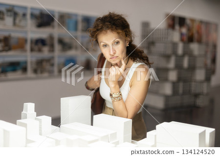Woman looking at contemporary art sculpture installation in museum Woman looking at contemporary art sculpture installation in museum 134124520