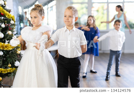 Children rehearsing ballroom dance for upcoming Christmas party at school Children rehearsing ballroom dance for upcoming Christmas party at school 134124576