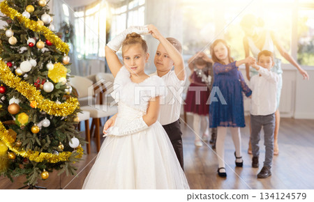 Children rehearsing ballroom dance for upcoming Christmas party at school Children rehearsing ballroom dance for upcoming Christmas party at school 134124579