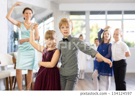 Children dance in pairs at festive matinee 134124597