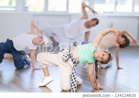 Tween girl dancer rehearsing krump dance at group workout Tween girl dancer rehearsing krump dance at group workout 134124610