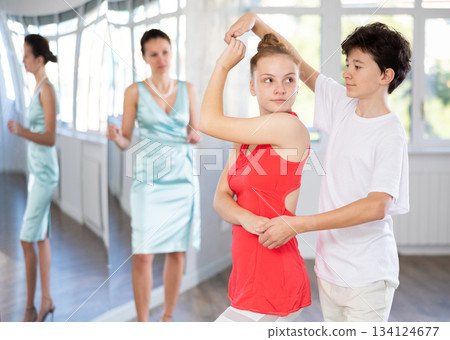 Girl and boy dancing slow ballroom dance in choreography studio 134124677