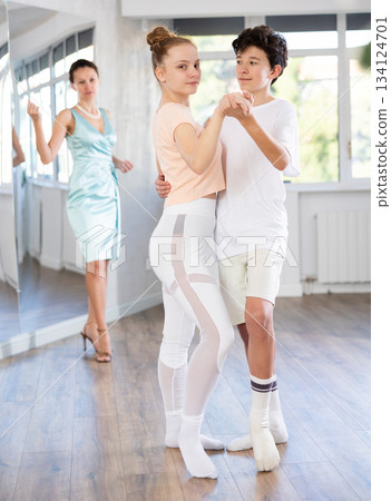 Passionate teen dancers, girl and boy practicing ballroom dancing in studio 134124701