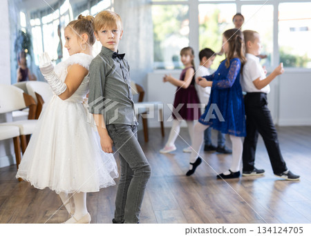 Happy little boys and beautiful girls dancing twist dance Happy little boys and beautiful girls dancing twist dance 134124705