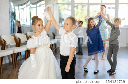 Children dance in pairs at festive matinee Children dance in pairs at festive matinee 134124719