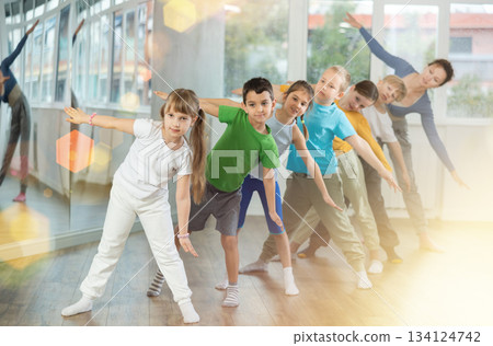 Preteen children engaged in choreography exercises in group Preteen children engaged in choreography exercises in group 134124742