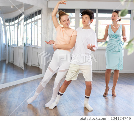 Girl and boy dancing slow ballroom dance in choreography studio 134124749