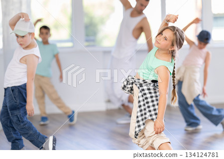Girls and boys training hip hop in dance studio, dance classes for kids Girls and boys training hip hop in dance studio, dance classes for kids 134124781