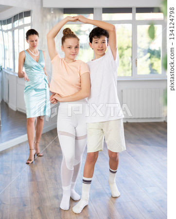 Passionate teen dancers, girl and boy practicing ballroom dancing in studio 134124798