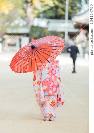 A girl holding a Japanese umbrella and visiting a shrine for Shichi-Go-San 134124799